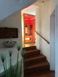 a staircase in a house with a red light at Chillige Ferienwohnung für 2! Loft A15 im Atelier in Fladungen +17 photos