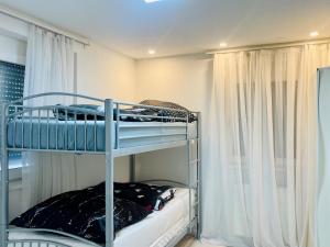 a bedroom with two bunk beds in a room at GraceHomes (Entry to Blackforest) in Jettingen