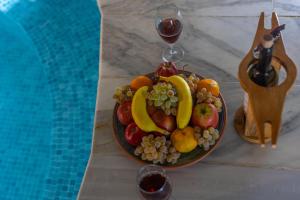 a plate of fruit on a table next to a pool at Belenus Cave House in Ürgüp