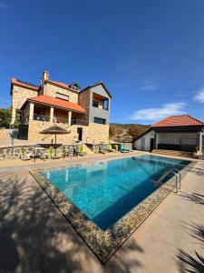 a swimming pool in front of a house at Maurice Bonjean in Ifrane