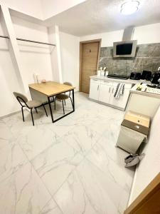 a kitchen and dining room with white marble flooring at Pension Hirsch in Berg +22 photos
