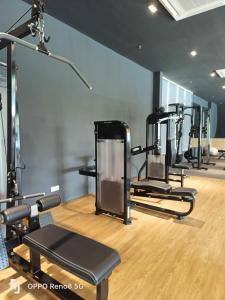 a gym with several tread machines in a room at Sweet Escape at Splashmania in Banting