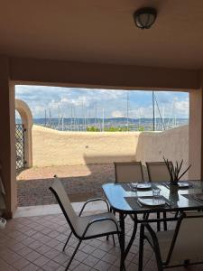 a patio with a table and chairs and a view of the ocean at Apartment Gabriella in Muggia
