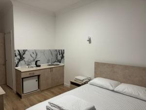 a bedroom with a bed and a sink at Жилой Комплекс Акжайык in Astana