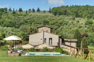 a villa with a swimming pool and a house at Amore Rentals - Ville Il Paradiso in Panzano