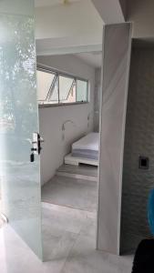 Una puerta que conduce a un dormitorio con cama en Apartamento com 1 quarto próximo à UFSC Trindade, en Florianópolis