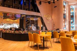 a restaurant with tables and chairs and a stage at Aloft by Marriott Ponce Hotel & Casino in Ponce