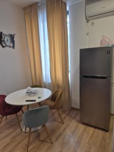 a small room with a table and a refrigerator at Avrig Dinu in Bucharest