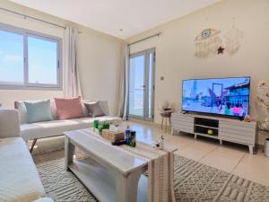 Телевизор и/или развлекательный центр в Stylish 1 BR with sea view - Sunset view