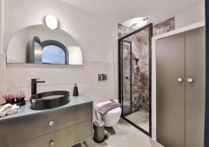 a bathroom with a sink and a toilet and a mirror at Nodus Tollens Apart in Kaş +48 photos