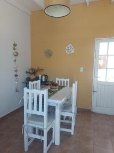 a white table and two chairs in a room at Departamento Cerca Parque Termal Rodo-Hue 2 in Dolores