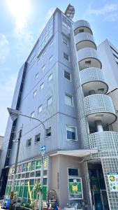 a tall building with a street light in front of it at Ansou house 大阪ドーム in Osaka