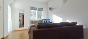 a living room with a couch and a window at Olive Tree House in Riva del Garda