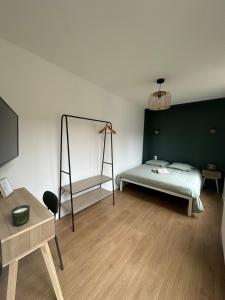 a room with a bed and a mirror in it at Appartement rénové hypercentre-Charleville-10p in Charleville-Mézières +5 photos