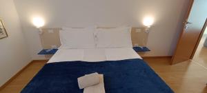 a bedroom with a large bed with pillows at Olive Tree House in Riva del Garda