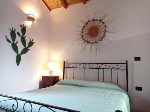 a bedroom with a bed and a mirror on the wall at Casa vacanze in Dimora Storica del 1500 in Martano