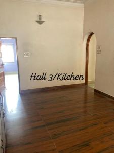 a room with a wall with the word hall kitchen on it at decent home stay in Belgaum