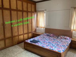 a bedroom with a bed in a room with aintendent at decent home stay in Belgaum