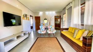 a living room with a couch and two chairs at CasaBelgaBrasil in Prado