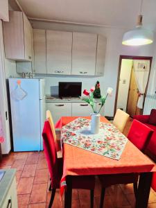 a kitchen with a table with a red tablecloth on it at La Casa di Brandolice in Vivo dʼOrcia