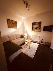 a living room with a couch and a table at Căsuța din povești in Oradea