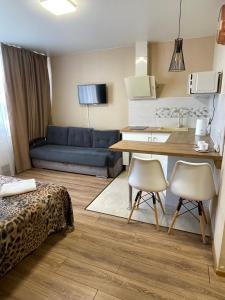 a kitchen and living room with a couch and a table at East Residence in Kyiv