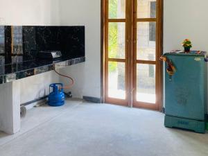 a room with an old refrigerator next to a door at Sparrow Villa Unawatuna in Talpe