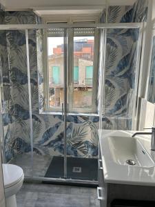a bathroom with a shower and a toilet and a sink at Le Terrazze Beachfront, balcony, parking, private access Beach in Torvaianica +26 photos