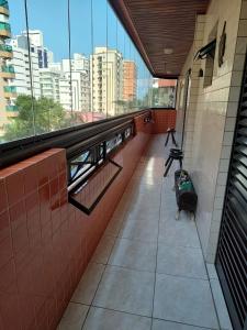 a train station with a luggage sitting on the floor at Apartamento, Praia Grande, Canto do Forte in Praia Grande