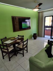 a living room with a table and a green wall at Apartamento, Praia Grande, Canto do Forte in Praia Grande +26 photos