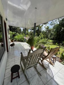 Agua AzulにあるVilla Granja Agua Azul-wi-fi-AC-6 Personas-parqueoのパティオ(椅子2脚、鉢植えの植物付きテーブル付)