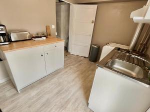 a kitchen with a sink and a counter top at Studio avec cuisine, salle de bain et garage privé proximité 24h in Le Mans