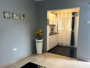 a kitchen with a toilet and a sink in a room at Kareber Solo in Gulu