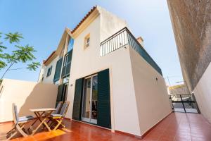 a view of the balcony of a house with a table and chairs at Madeira Dreams in Caniço