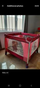 a pink bed in a room with avertisement at Ground Floor Lovely two bedrooms apartment in Flic-en-Flac +10 photos
