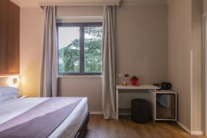 Postel nebo postele na pokoji v ubytování Garner Hotel Rome Aurelia by IHG