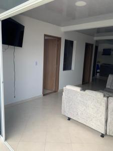 a living room with a couch and a flat screen tv at Apartamento Tranquilo in Villavicencio