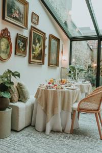 a dining room with a table with food on it at The Burgundy - Boutique B&B in Bruges