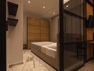 a bedroom with a bed and a sliding glass door at Cozy Living Apartment in Ioannina