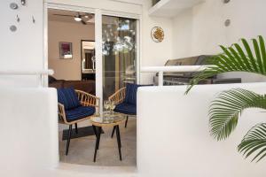 a living room with blue chairs and a table at Pool, Near Marinas, Reefs, Family Fun, 2BR Condo, Main Level in Cozumel