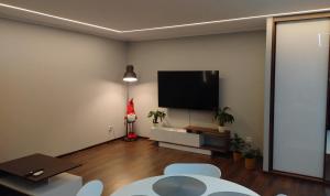 a living room with a flat screen tv on a wall at Lagan Apartament - doskonała baza w Aglomeracji Śląskiej in Będzin