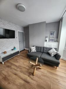 a living room with a couch and a table at Manor hause walsall 4 in Walsall