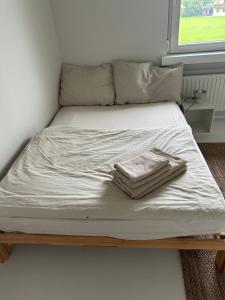 a bed with white sheets and two towels on it at Casa Móre SMALL in Niederalm