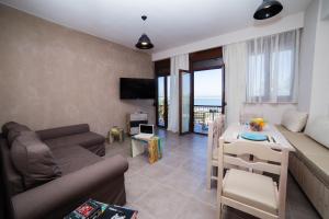 a living room with a couch and a table at Prokymaia Penthouse Apartment in Rethymno