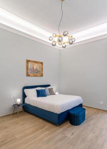 Ένα ή περισσότερα κρεβάτια σε δωμάτιο στο Palazzo Galeoni Luxury Suites