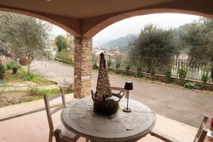 a table with a vase on it on a patio at la taverna di Caterina in Pontassieve