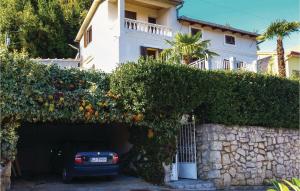 a car parked in a garage in front of a house at Pet Friendly Apartment In Moscenicka Draga in Mošćenička Draga