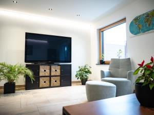 a living room with a flat screen tv on a wall at Haus Wanderlust in Saint-Vith