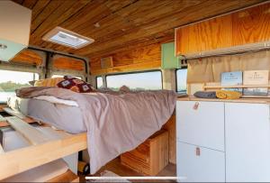 a bed in the inside of a bus with a counter at Transi the Van in Düsseldorf +21 photos