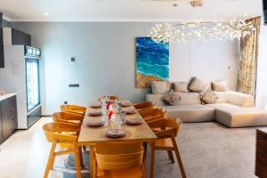 a living room with a table and chairs and a couch at SULO VIP Spa in Atyrau